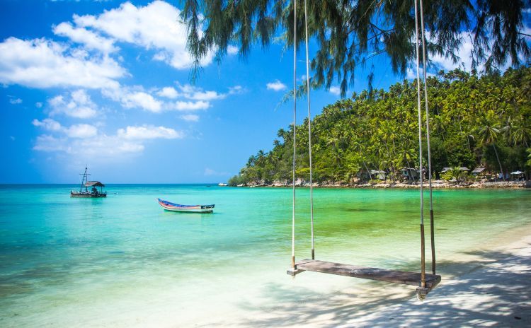 Swing hang from a coconut tree over beach, Phangan island