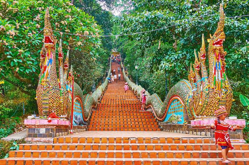 The long staircase of Wat Phra That Doi Suthep temple is decorated with jeweled Naga serpents