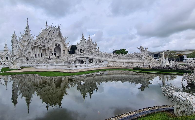the most famous of the temples in Chiang Rai, the White temple reflected