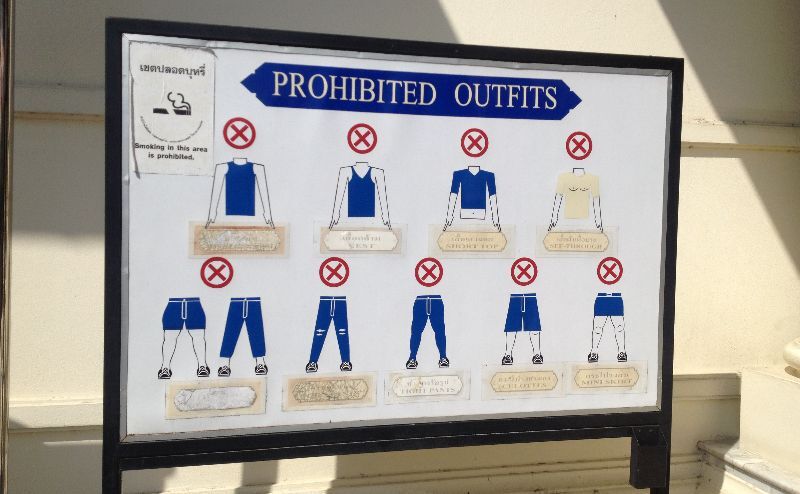 Temple Etiquette in Thailand sign outside temple showing appropriate clothing
