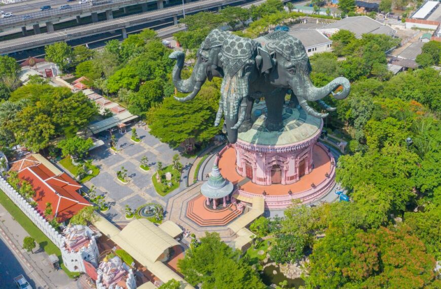 an elephant statue at the Erawan Museum in Bangkok surrounded by trees