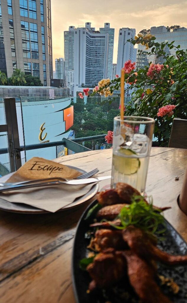 Happy hour wings and drinks at Escape rooftop bar in Phom Phrong Bangkok