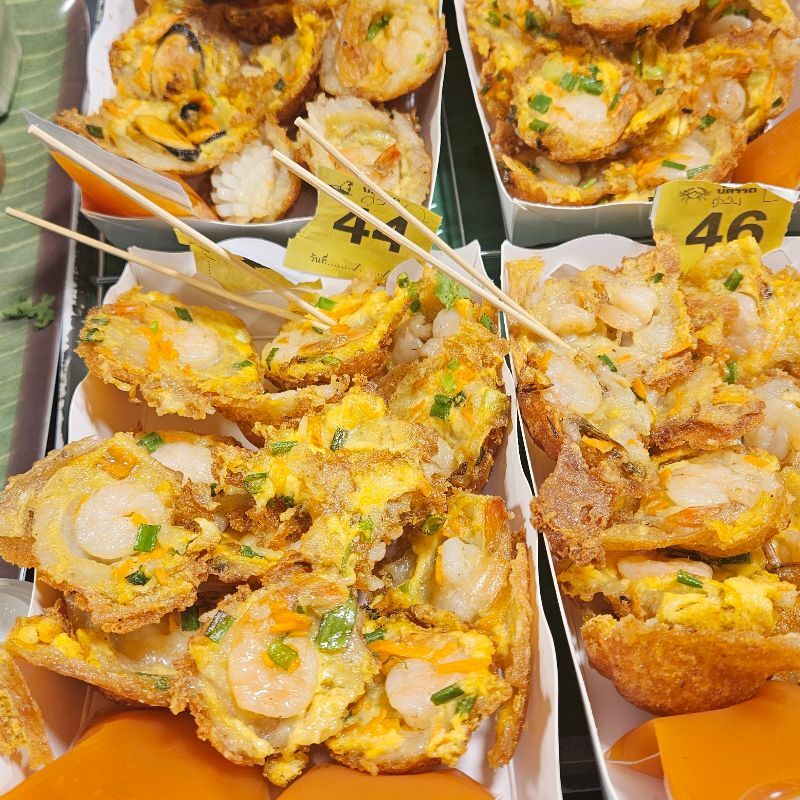 seafood pancakes featuring shrimp at floating market in Bangkok