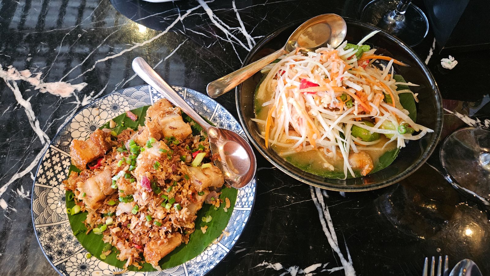 Thai food a Papaya salad and crispy pork