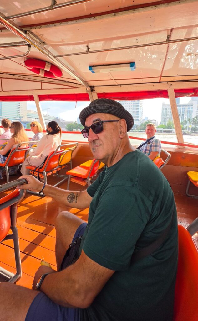 charles riding the orange flag boat in bangkok